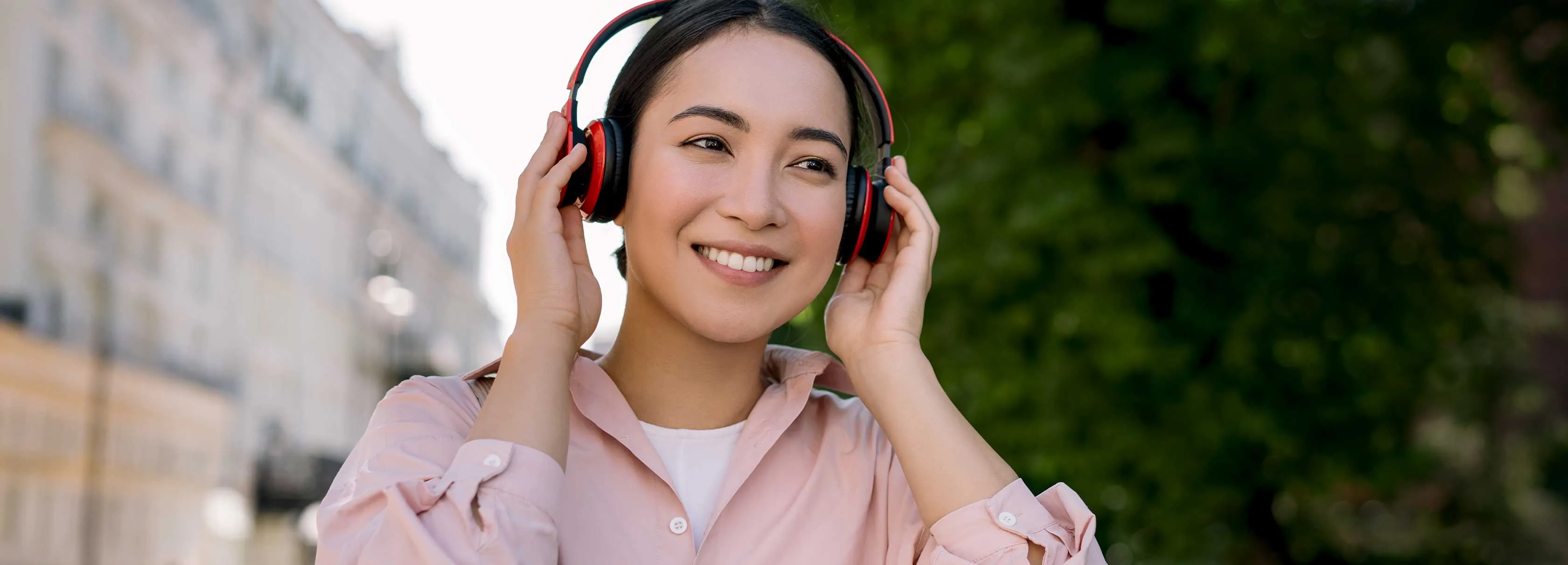 A woman wearing headphones and smiling